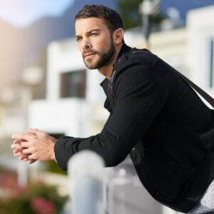 contemplative-man-relaxing-outdoors-in-urban-settings